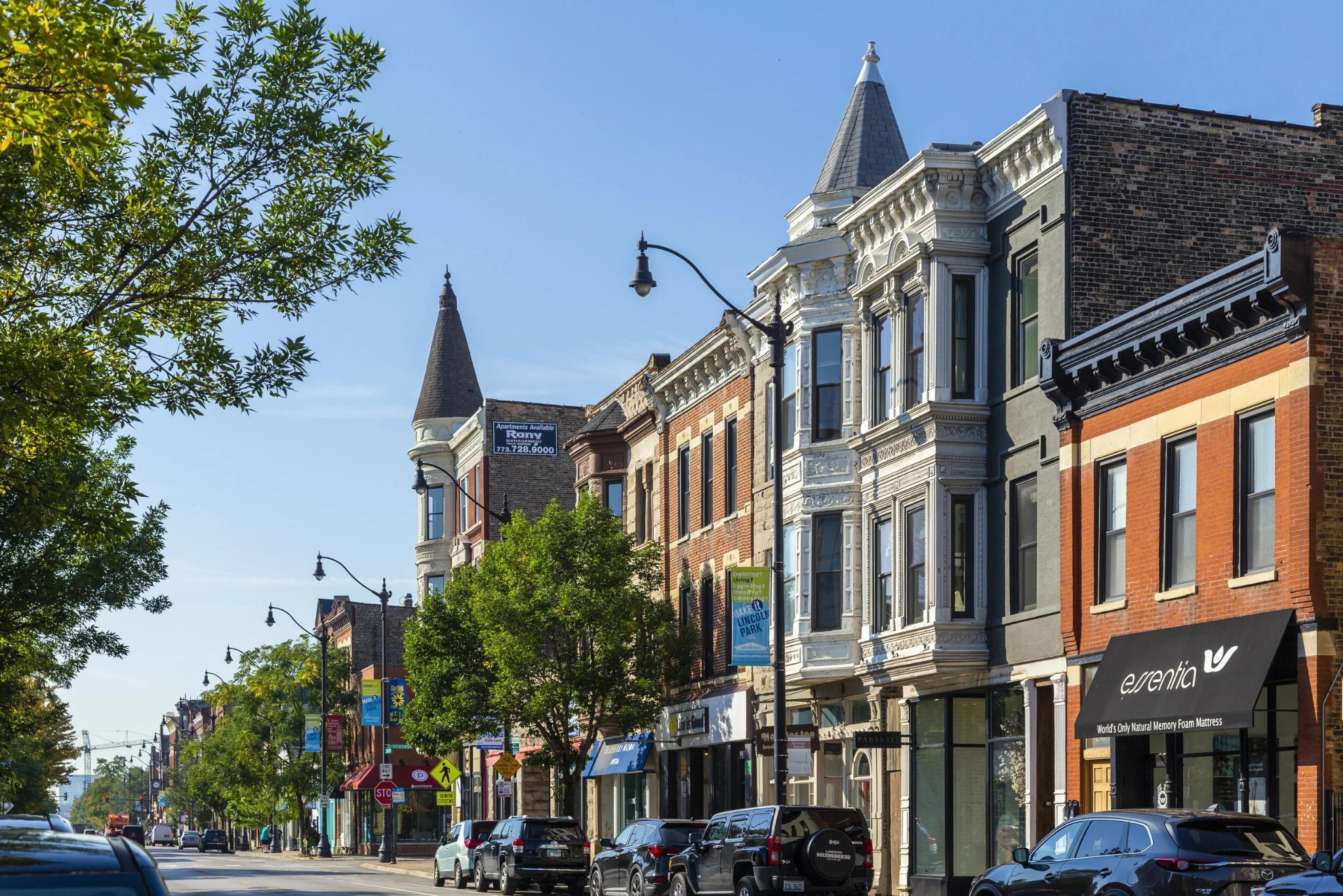 Brick storefronts and parked cars along Armitage Avenue.