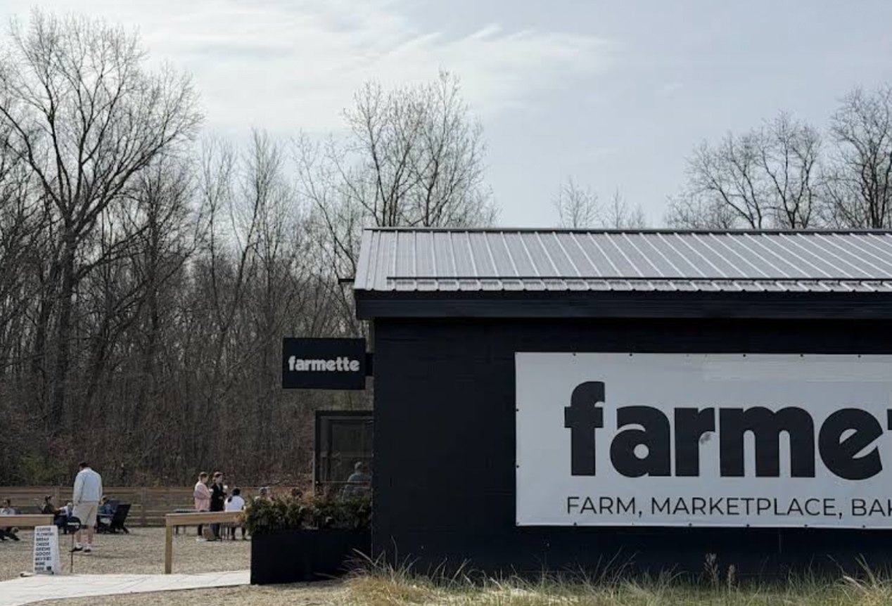 Farmette on Red Arrow Highway, a black modern farm building with a big white sign reading farm, marketplace, bakery and cafe.